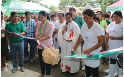 <p><strong>HERBAL FOOD</strong>. Quezon ALONA partylist Representative Anna Villaraza Suarez (in pink dress), assisted by the women food processing workers, cuts the ribbon and joins the blessing rite for the new food and herbal processing center in Barangay Talipan in Pagbilao, Quezon last June 1. The new food processing facility produces healthy snack food than the common “junk foods” that dominate children's food stuffs. <em>(Photo by Quezon PIO)</em></p>